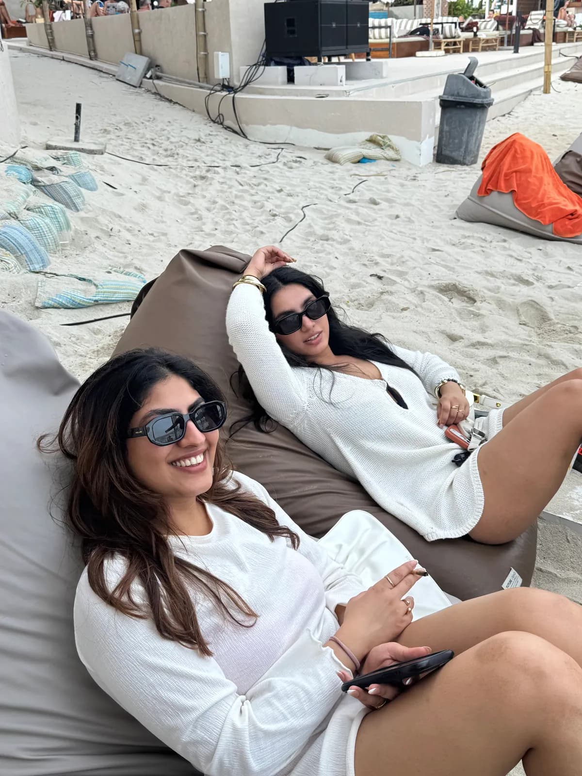 Friends lounging on beanbags by the sea